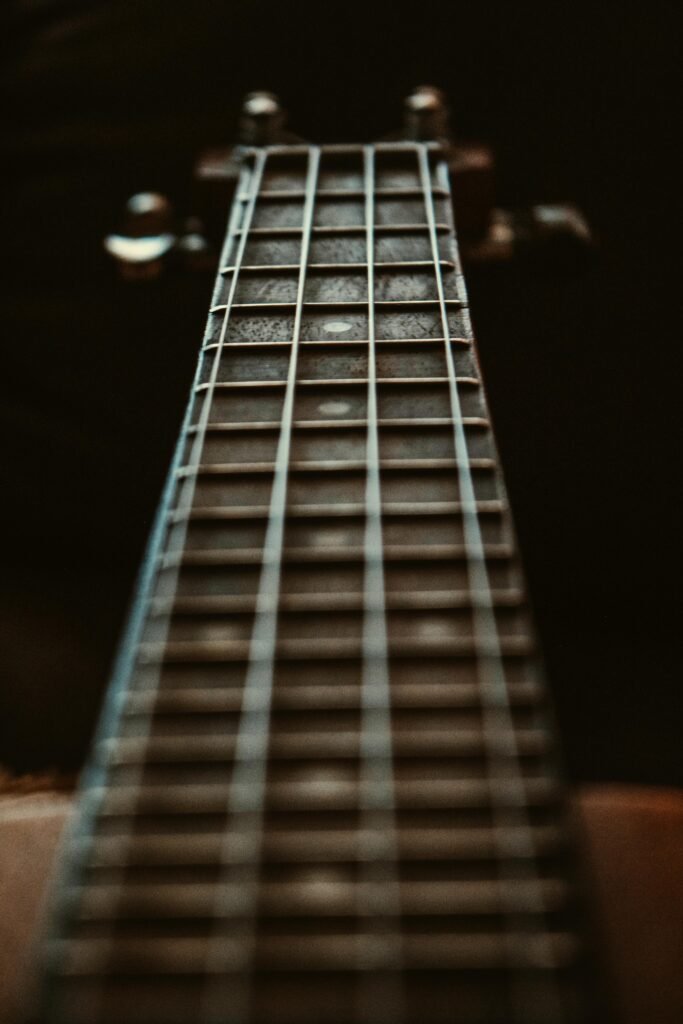 pexels-photo-1808343-1808343 Artistic close-up of a guitar fretboard focusing on the strings and frets with a depth of field effect.